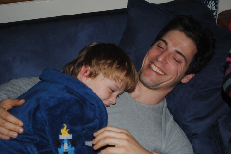 William cuddling with Uncle Dan on the couch