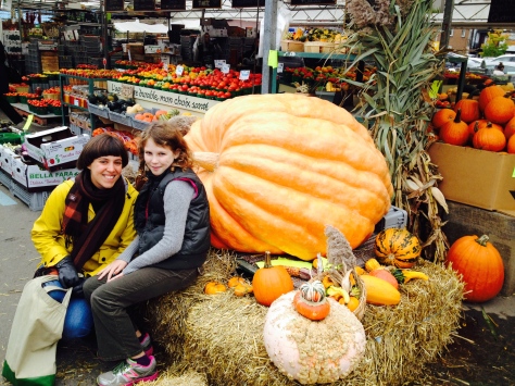 Charlotte and Katie with giant (but real!) pumpkin at the Market.