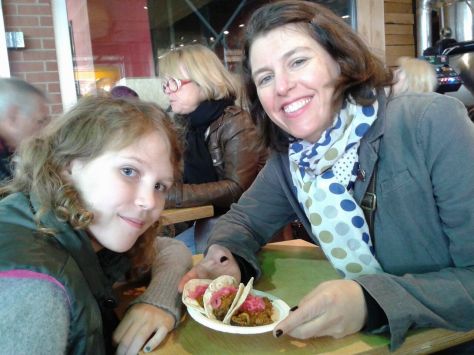 Charlotte and me at Jean Talon Market with pulled-pork tacos - yum!